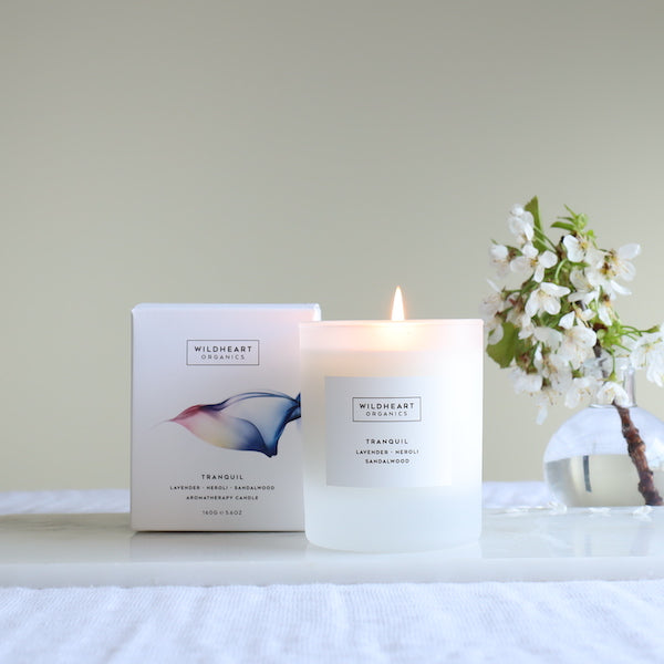 serene image of calming candle with botanical vase